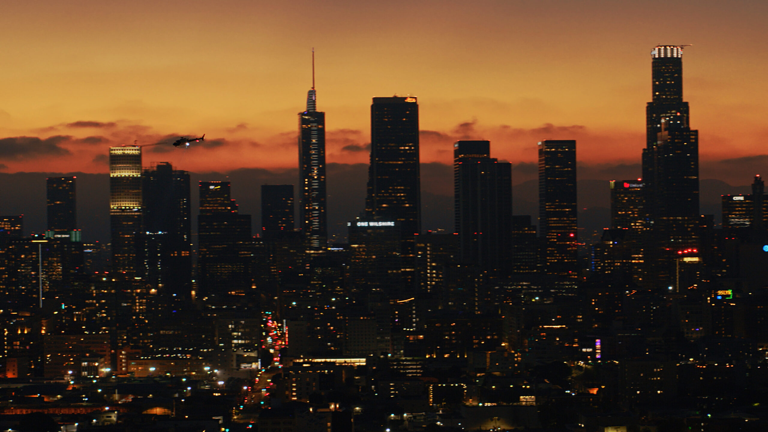 Police Department helicopter in pursuit over downtown Los Angeles at sunset, captured by AMK Films.